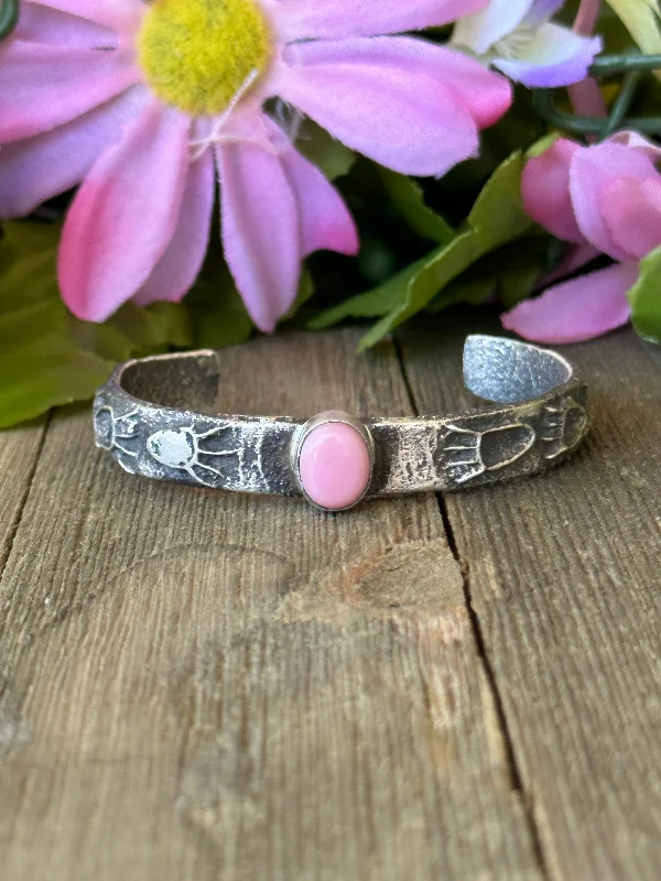 Women's Cuff Bracelets with Hamsa Hand Charms for Protection and Good LuckNavajo Made Pink Conch & Sterling Silver Tufa Cast Cuff Bracelet