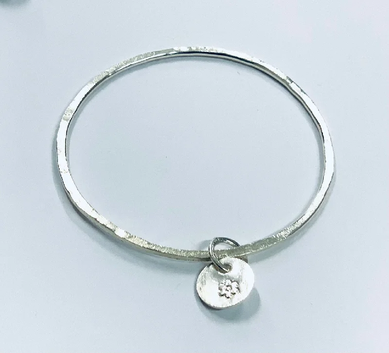 Handmade Bangle Bracelets with Polymer Clay Designs for a Personal TouchThin silver bangle with round charm