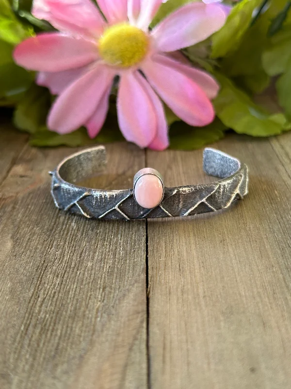 Stackable Women's Cuff Bracelets in Different Sizes and Materials for Layered StylingNavajo Made Pink Conch & Sterling Silver Tufa Cast Cuff Bracelet